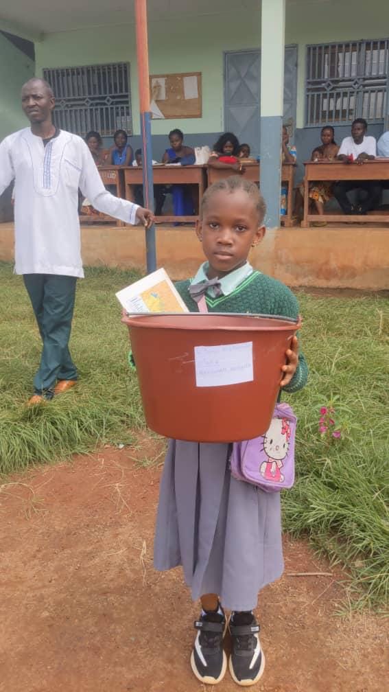 A MIYA learner receiving school supplies